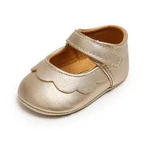 Detail view of gold metallic baby princess shoes with scallop trim and velcro strap