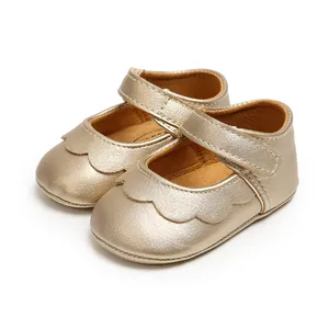 Detailed macro view of golden scalloped PU leather baby princess shoes with soft sole