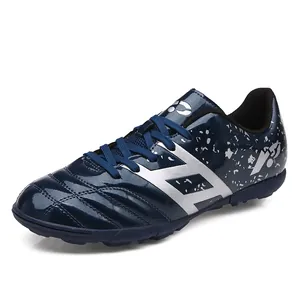 Professional blue kids turf soccer shoes for boys with stylish silver splash patterns