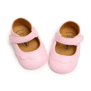 Close-up view of pink PU leather baby walking shoes with scalloped edges