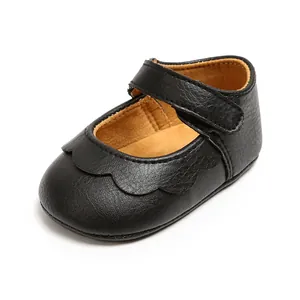Detailed view of black PU leather baby Mary Jane shoes with scalloped toe design.