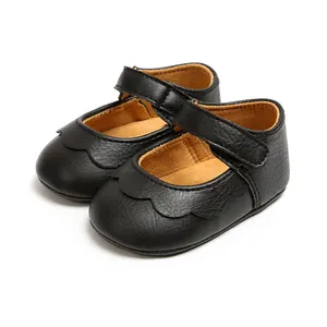 Side view detail of black PU soft sole baby princess shoes with scalloped edges