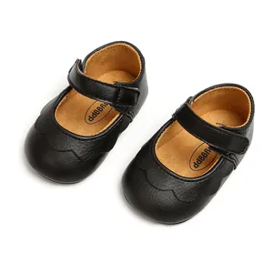 Close-up of black PU leather baby Mary Jane shoes with scalloped edges and Velcro strap