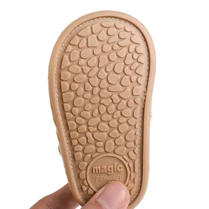 Detailed macro view of the non-slip pebble-textured tan sole for baby prewalker shoes