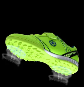 Detailansicht limegrüner Kinder-Fußballschuhe mit Noppensohle und Klettverschlussriemen