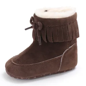 Close-up of brown infant winter snow boots with fringe and warm faux fur lining
