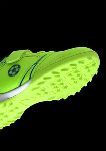 Detailansicht der neongrünen Kinder-Fußballschuhe mit strapazierfähigen Turf-Stollen