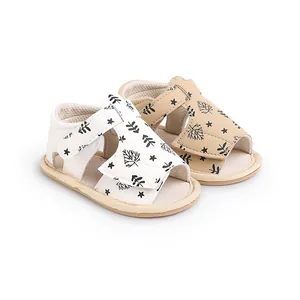 Detailed view of baby beach sandals with black leaf and star print patterns for infants