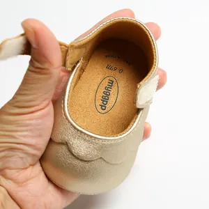 Detailed view of gold baby Mary Jane shoe interior showing soft insole and brand logo