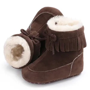 Warm brown baby winter snow boots featuring soft white fleece lining and fringe details.