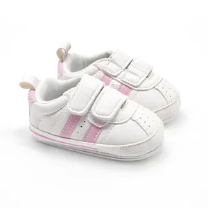 Close-up of breathable white baby walker shoes with pink stripes and rubber soles