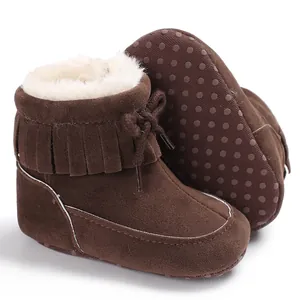 Detail view of brown baby winter snow boots with soft fringe and warm fur lining