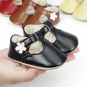 Close-up of infant black faux leather princess shoes with flower detail for 0-1 year old