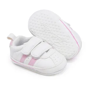 White baby walking shoes with pink stripes and non-slip rubber soles for toddlers