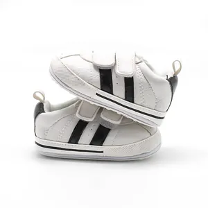 Comfortable white baby walking shoes with two black stripes and non-slip rubber soles
