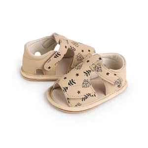 Detailed macro view of beige summer baby walking sandals featuring star and leaf prints