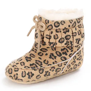 Close-up view of leopard print infant winter snow boots with fleece lining and fringe