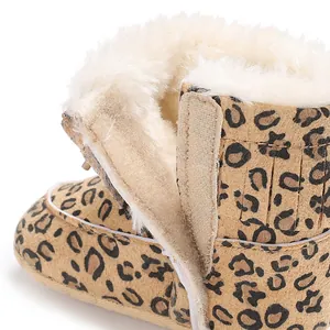 Close-up of leopard print infant snow boot with warm faux fur lining