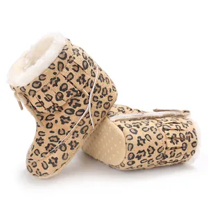 Detail view of leopard print infant snow boots with warm faux fur lining and fringe