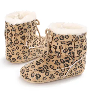 Detailed side view of baby snow boots with leopard print and plush fur lining