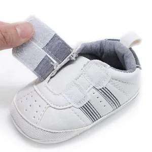 Close-up showing the adjustable velcro strap detail on these white baby walker shoes