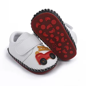 Vue détaillée de chaussures de marche pour bébé blanches avec motif camion de pompiers