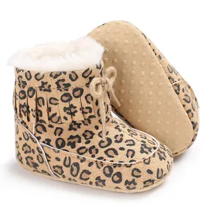 Detailed view of leopard print baby snow boots with fringe and warm lining.