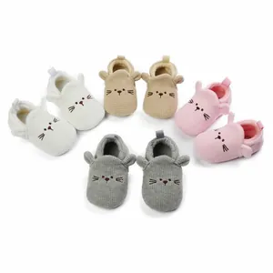 Macro view of cartoon baby pre-walker shoes in four soft pastel colors with ears.