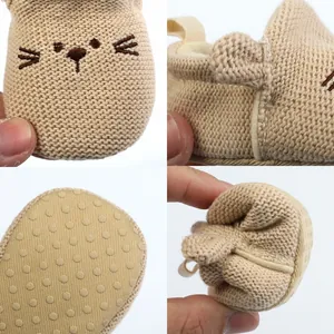 Close-up of soft knitted baby shoes with cute animal embroidery and non-slip sole