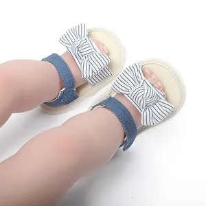 Nahaufnahme von Baby-Sommersandalen mit gestreifter Schleife und weichen blauen Riemen
