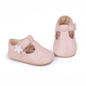 Detailed shot of pink baby girl princess shoes with white flower decoration and Velcro strap