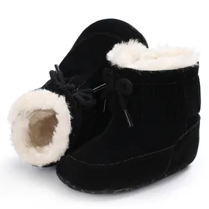 Cozy black baby snow boots with white faux fur lining and stylish fringe details
