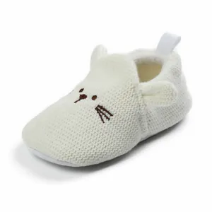 Detailed view of soft white knitted baby walking shoe with adorable cartoon cat design