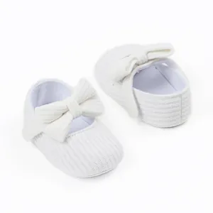 Detail view of soft white ribbed knit baby princess walker shoes with bow decoration