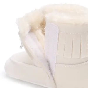 Close-up view of baby winter snow boot featuring warm fleece lining and velcro fastener