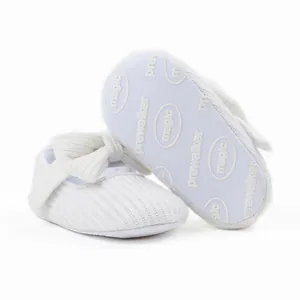 Detailed view of white knitted baby pre-walker shoe sole with anti-slip magic pattern.