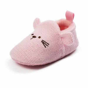 Detailed view of pink knitted baby shoes featuring a cute cartoon mouse face design
