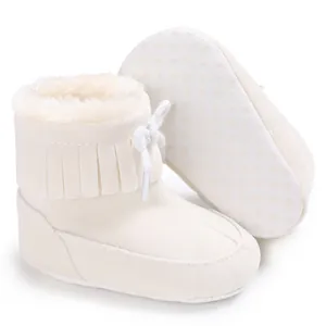 Warm faux fur lined baby snow boots with fringe detail and non-slip dotted sole