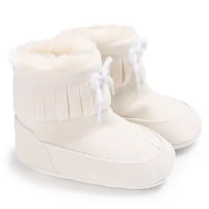 Detailed view of cream plush baby snow boots with soft fringe and extra warm lining.