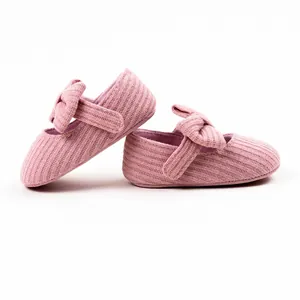 Detail view of pink knit baby walker shoes featuring a cute bow and textured fabric