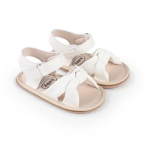Soft white baby walker sandals with bow detail and velcro strap