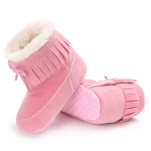 Pink baby winter boots with warm faux fur lining and fringe details for infants