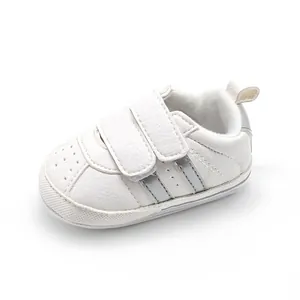 Detailed view of white breathable baby walker shoe with silver stripes and Velcro