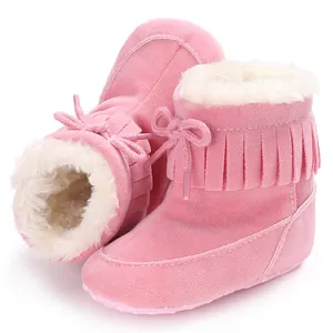Cozy pink baby snow boots with fringe detail and soft white fleece lining