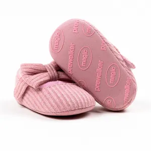 Detailed macro view of pink knit baby prewalker shoes featuring bow and anti-slip rubber sole