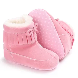 Detailed view of pink baby snow boots featuring warm fleece lining and non-slip dotted soles