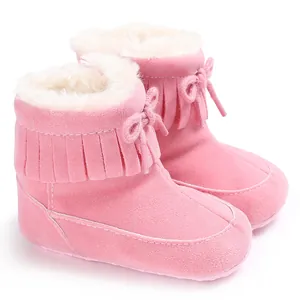 Pink infant winter snow boots with fringe tassels and warm fleece lining for 0-1 year olds.