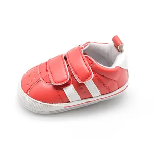Detail view of breathable red baby walking shoe with non-slip sole and white stripes