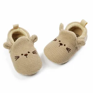 Detail view of soft knitted beige baby walker shoes featuring a cute embroidered animal face.