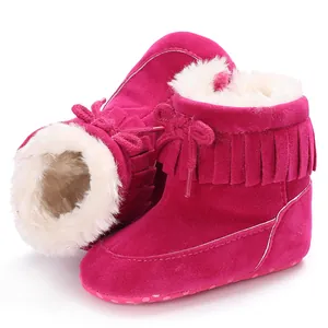 Detailed view of pink baby winter snow boots with warm faux fur lining and fringe